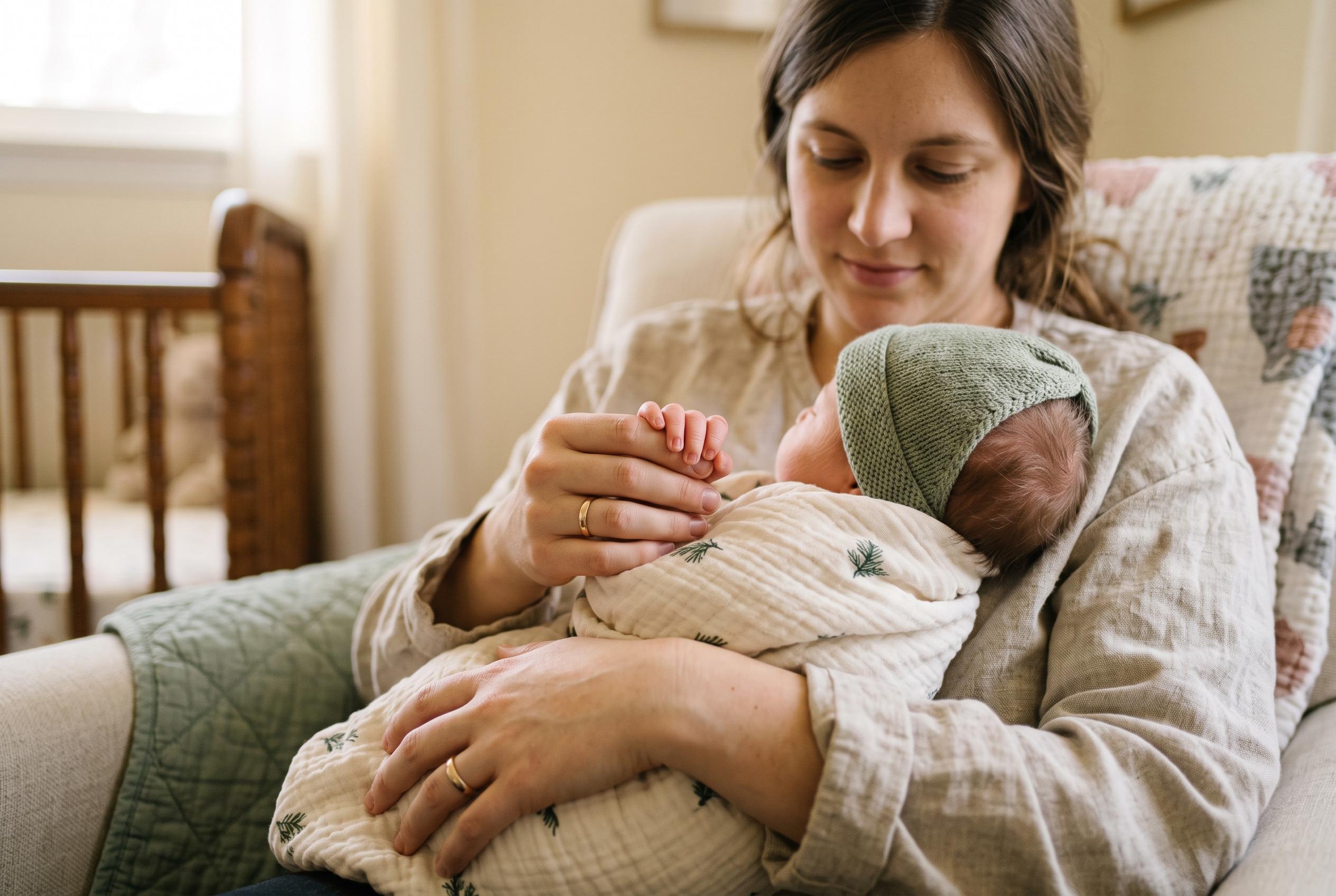 A parent cradling a newborn's hand